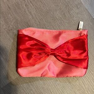 Ipsy pink with red Satin Bow small makeup/jewelry bag.